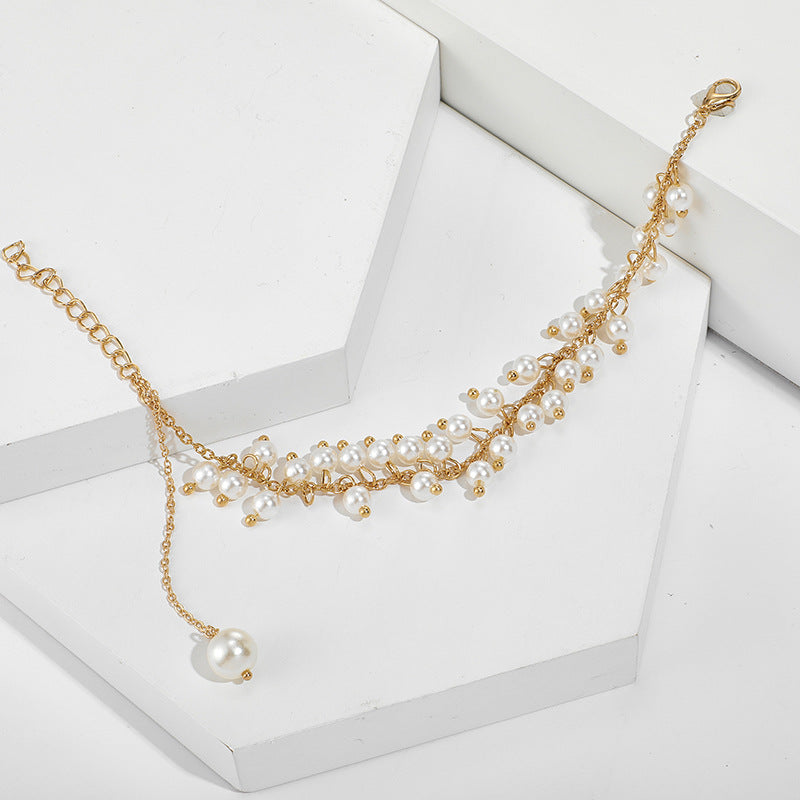 VAKKERT ARMBÅND MED PERLER