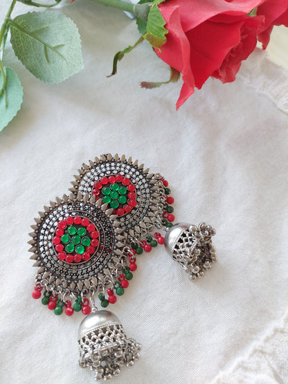 Sølvfarget ørepynt med dataljer i rødt